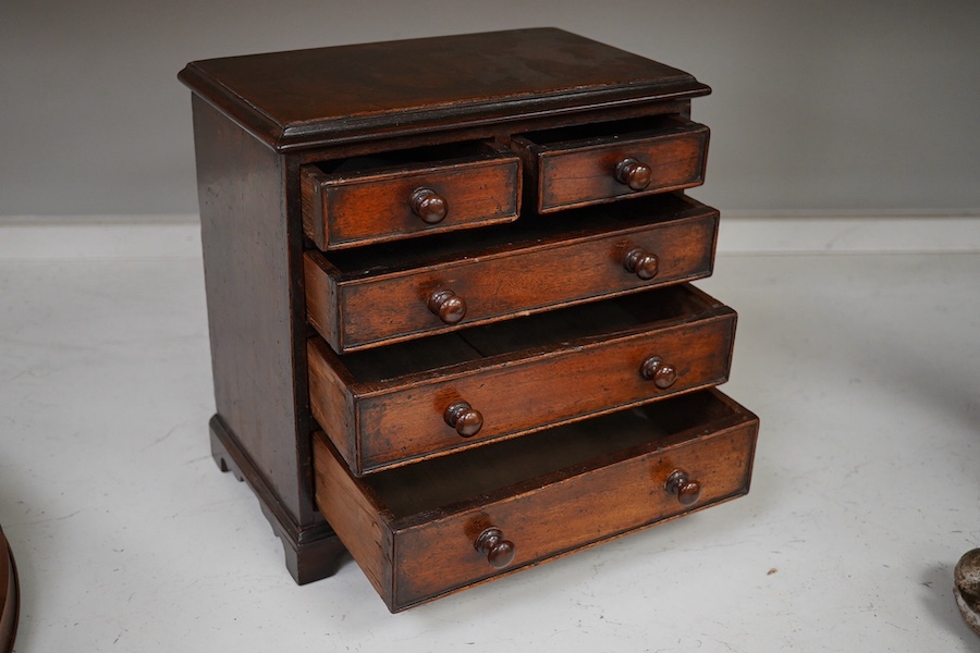 A 19th century miniature mahogany chest of five drawers, 28cm high. Condition - fair to good